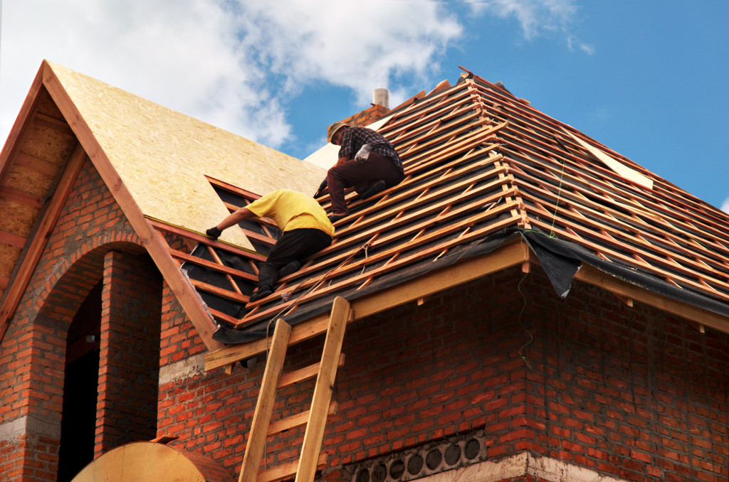 two men fixing roof