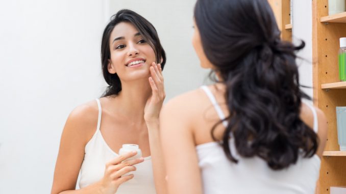 woman applying face cream