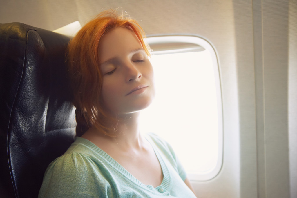 woman sleeping on plane