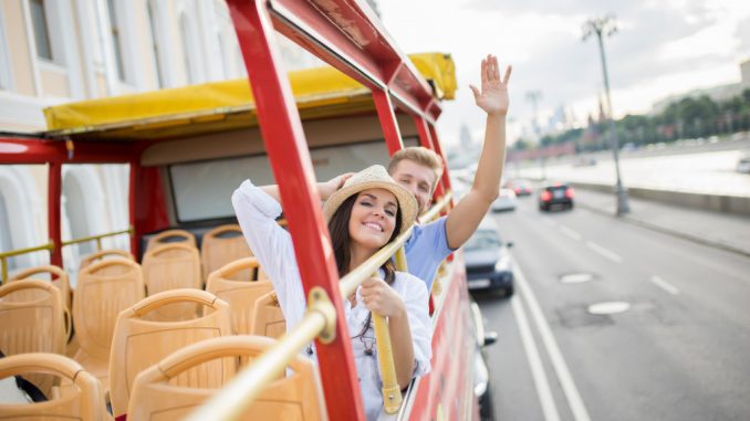 couple riding on a tourist bus