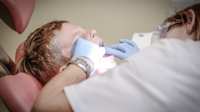 dentist checking up a boy